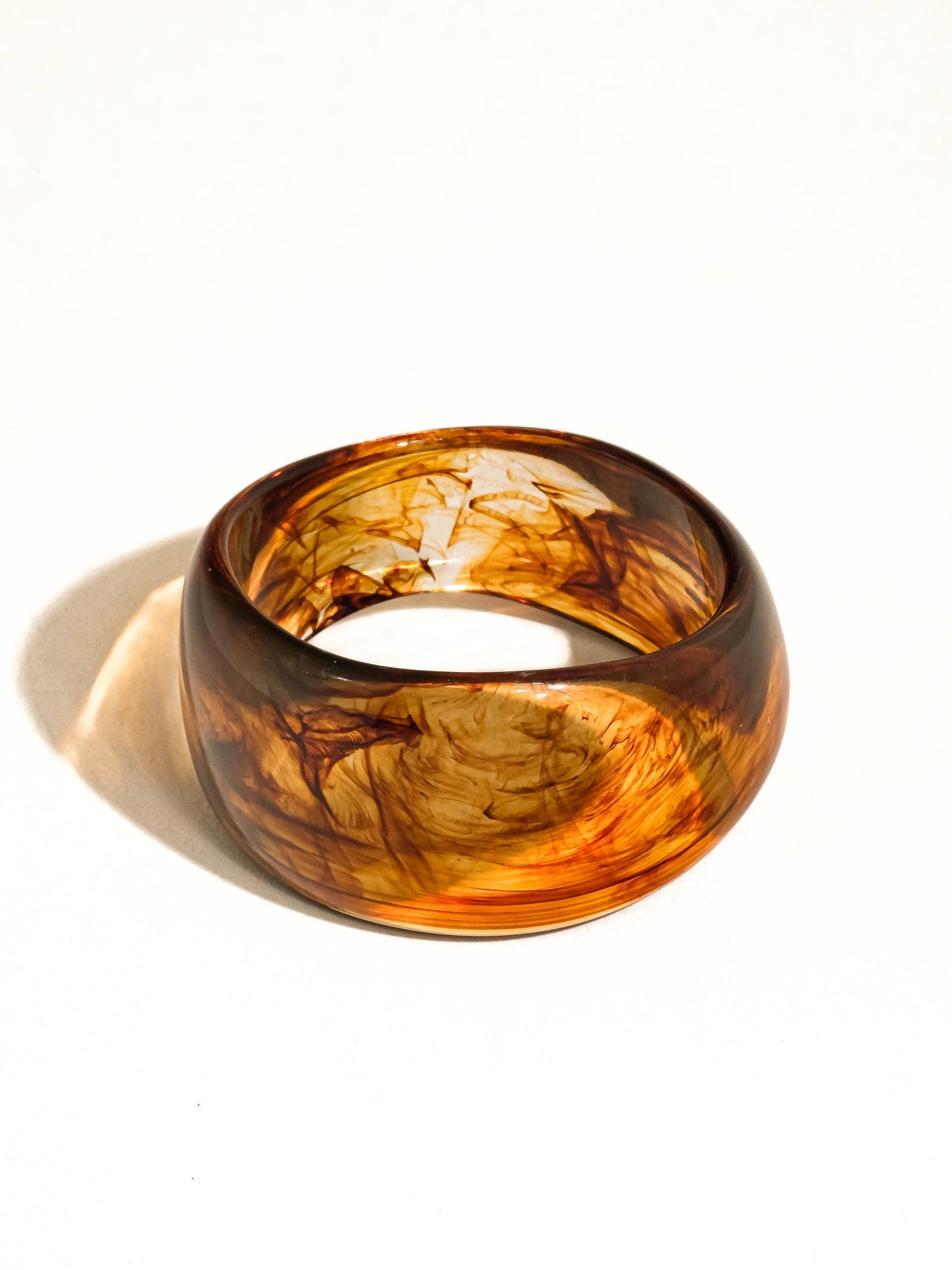 Brown tortoise bangle on a white background
