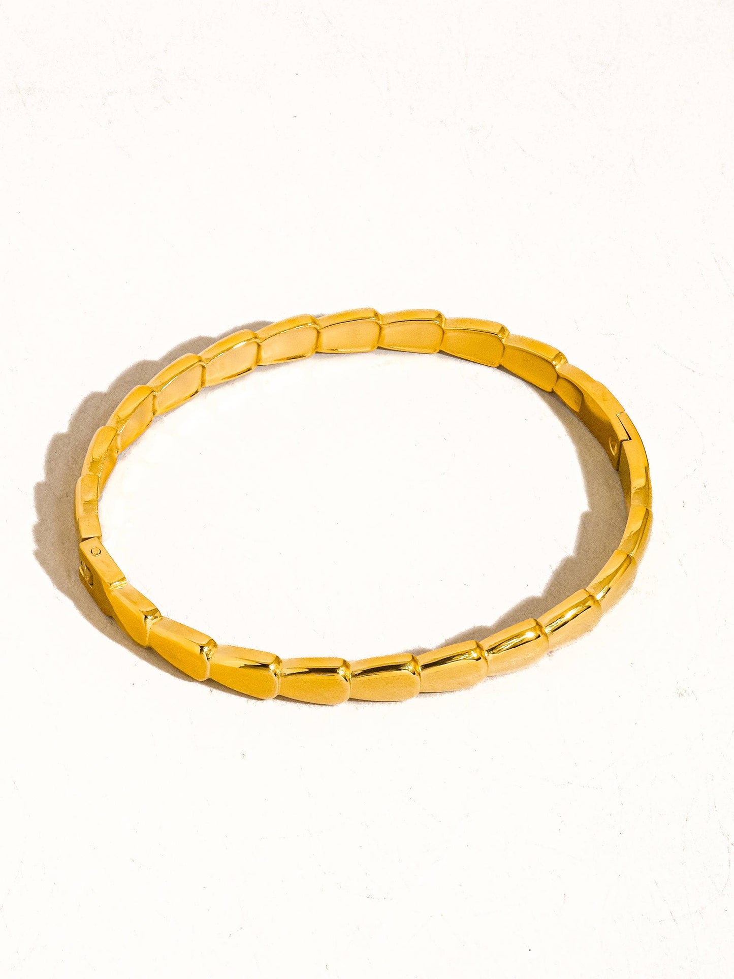 Gold bracelet on a white background