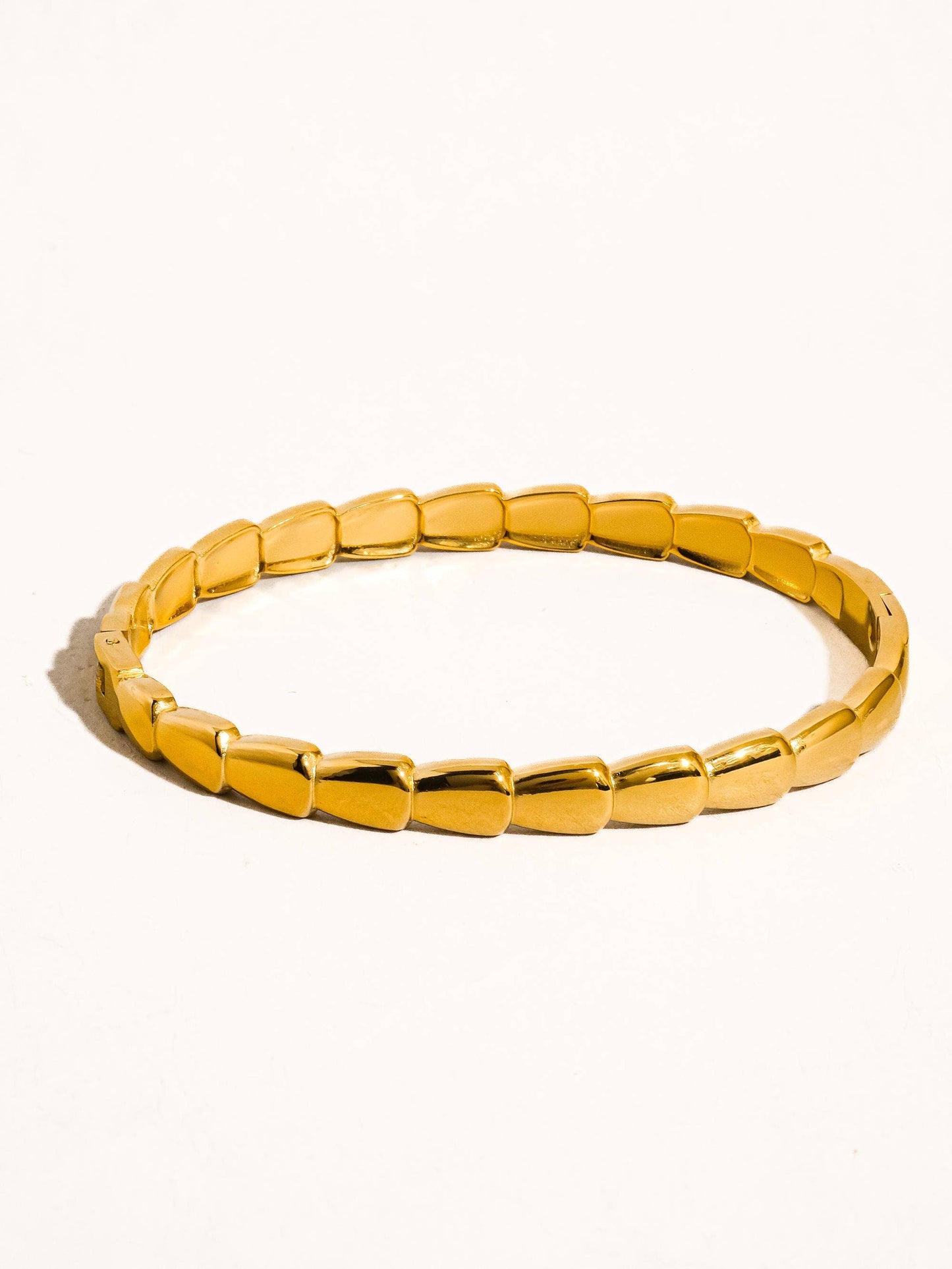 Gold bracelet on a white background