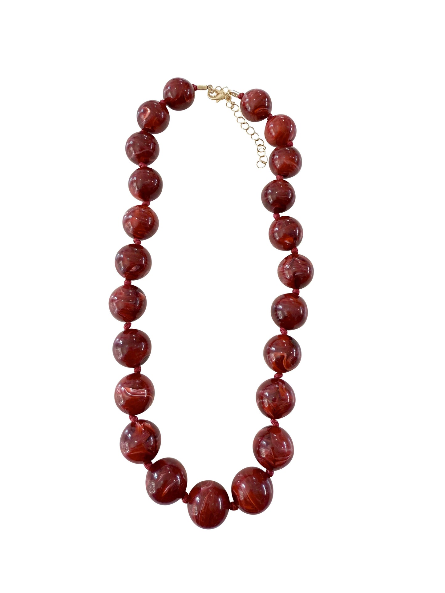 Red beaded necklace on a white background