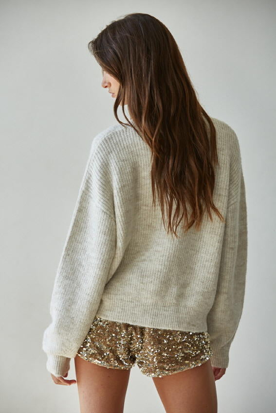 Women wearing oatmeal cardigan with pearl buttons