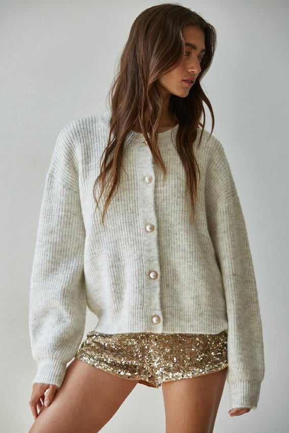 Women wearing oatmeal cardigan with pearl buttons