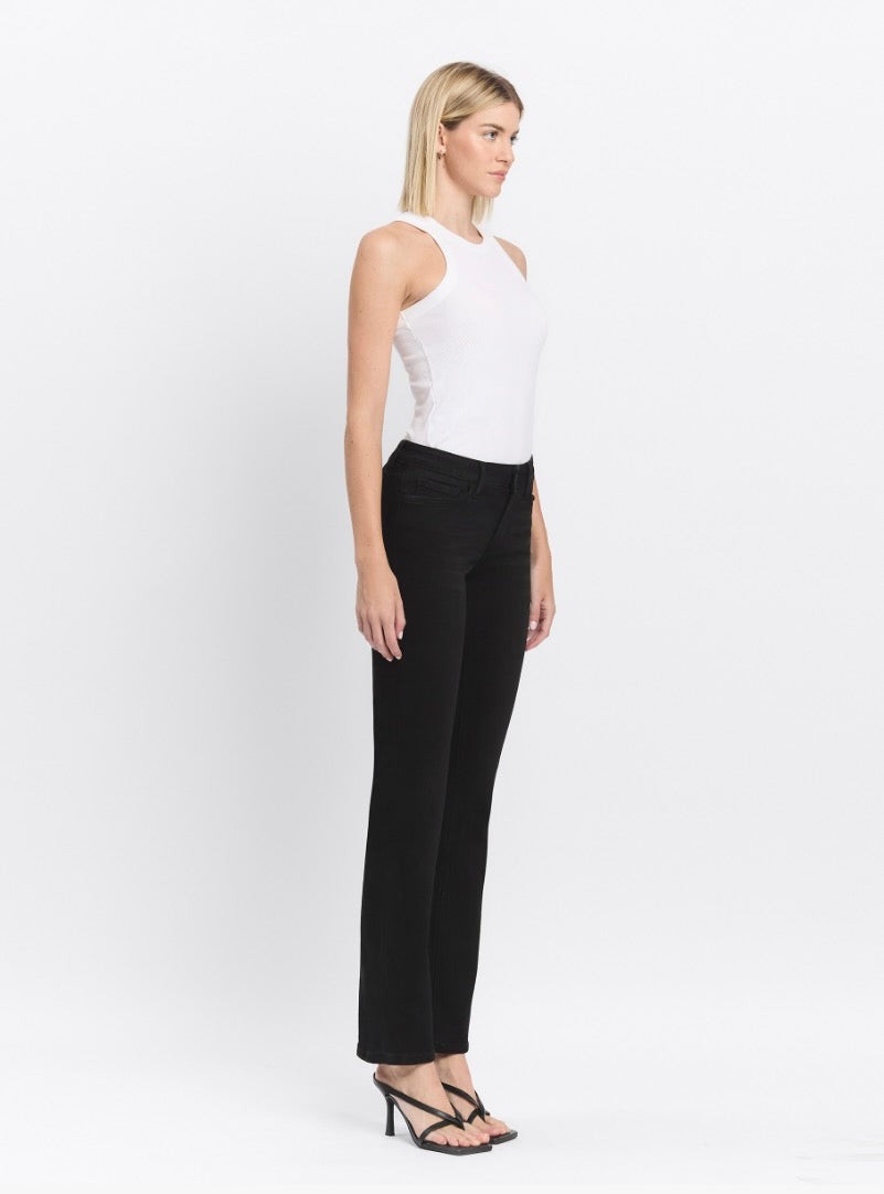 Woman wearing a white sleeveless top and black pants on a white background