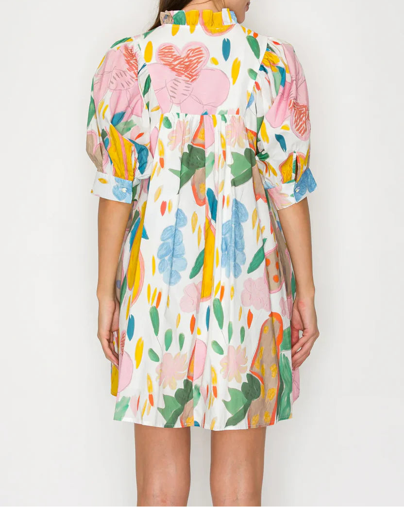 Woman wearing a colorful floral dress on a white background