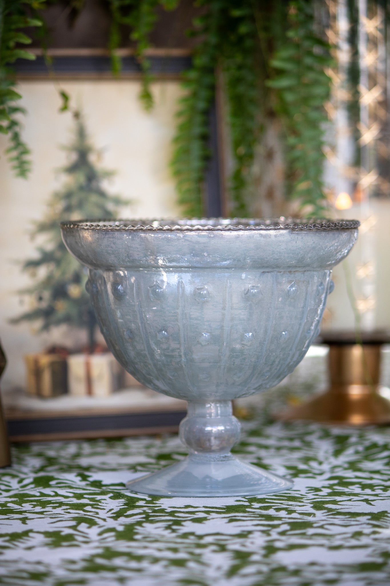Decorative glass bowl on a patterned surface with blurred background