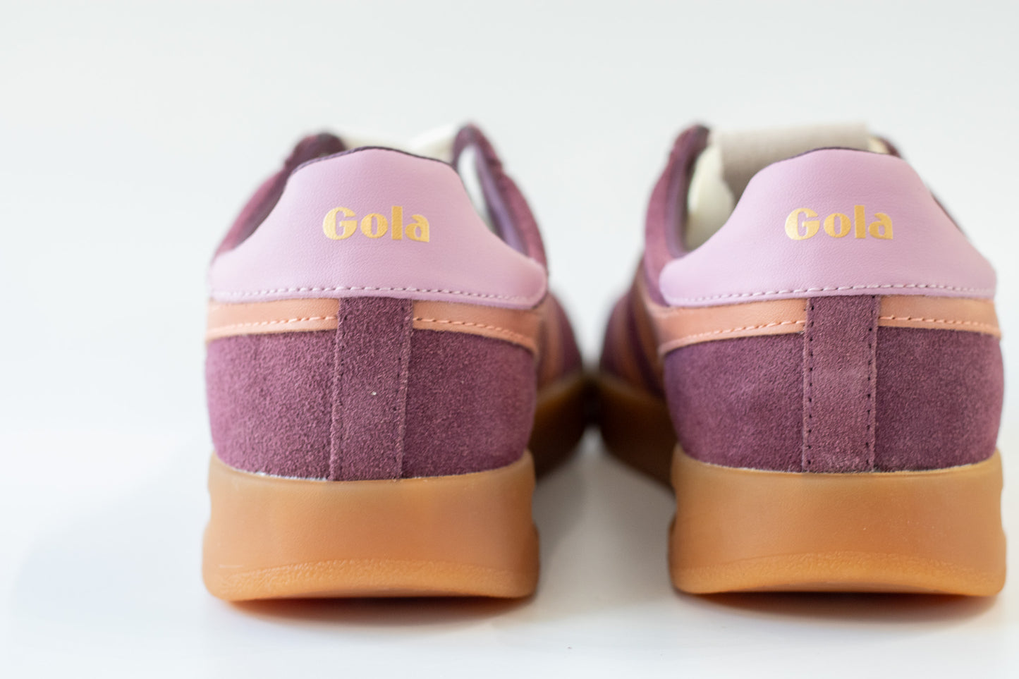 Pair of wine sneakers with Terracotta accents on a white background