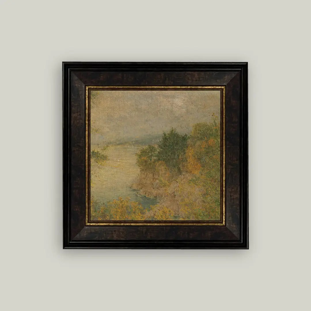 Framed painting of a landscape with trees and water on a light gray wall.