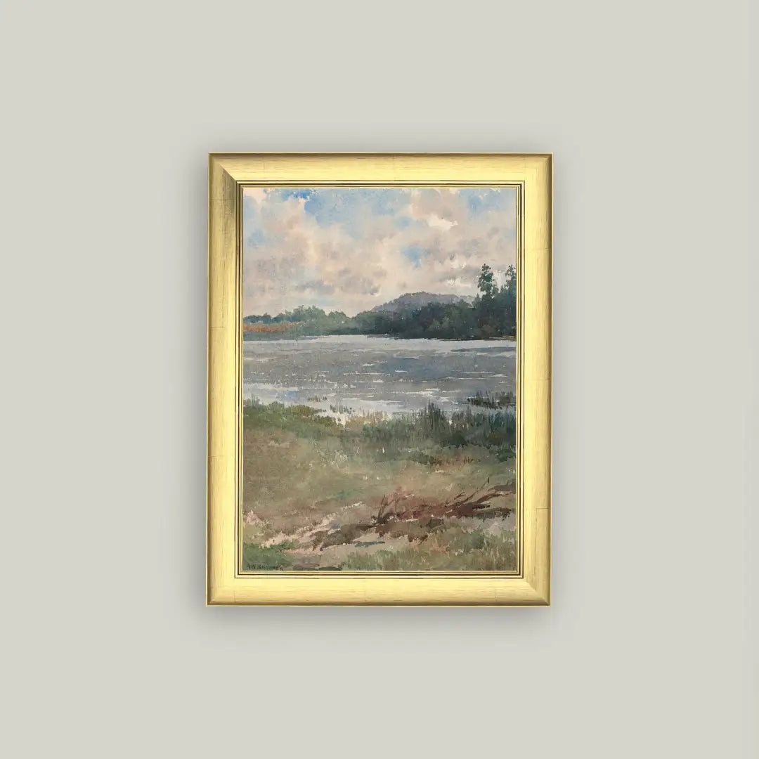 Framed painting of a landscape with water and sky on a gray wall