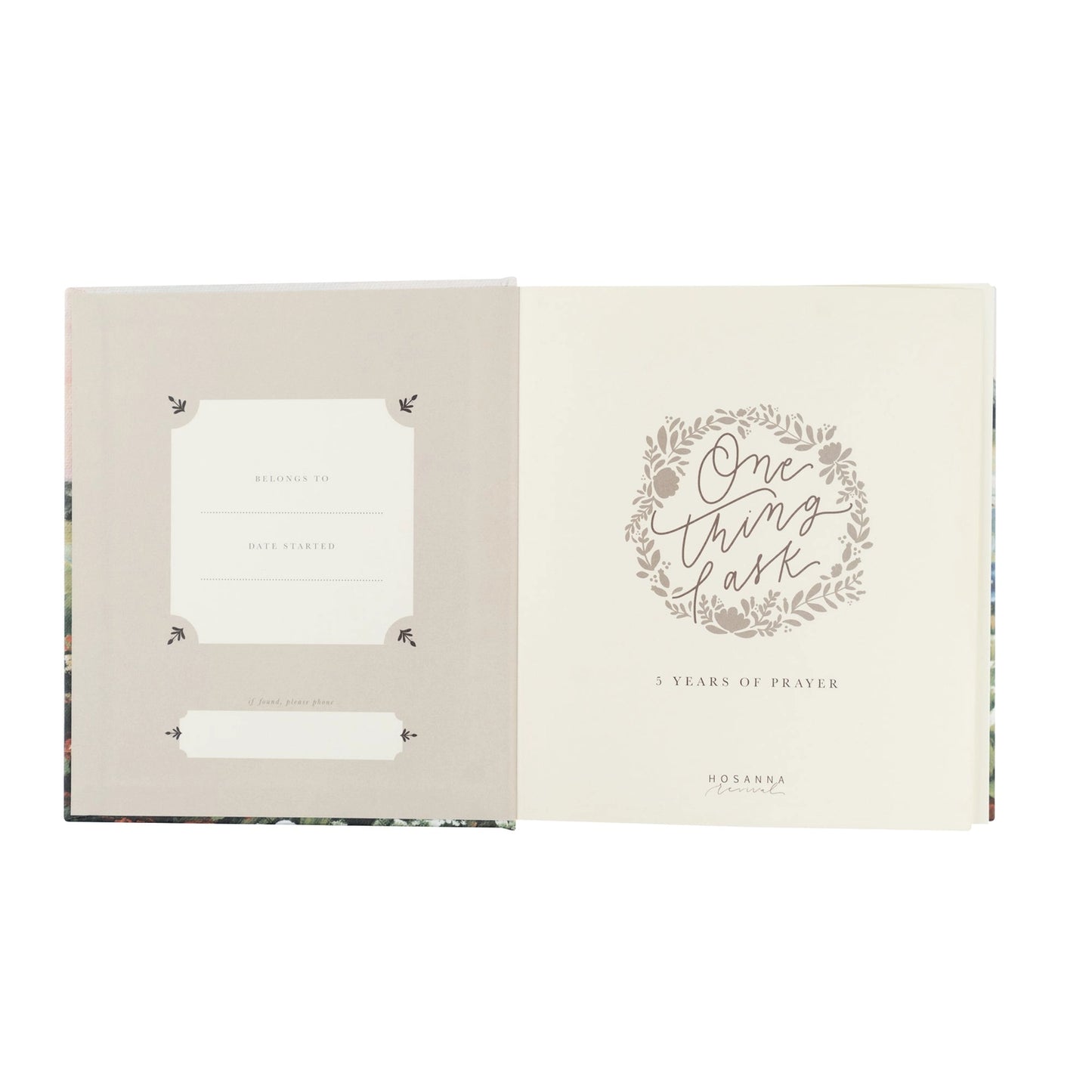 An open book or journal shown against a white background, with the left page in a light warm gray-beige tone and the right page in cream featuring a floral wreath and the words 'One thing at a time' and '3 Years of Prayer.'.