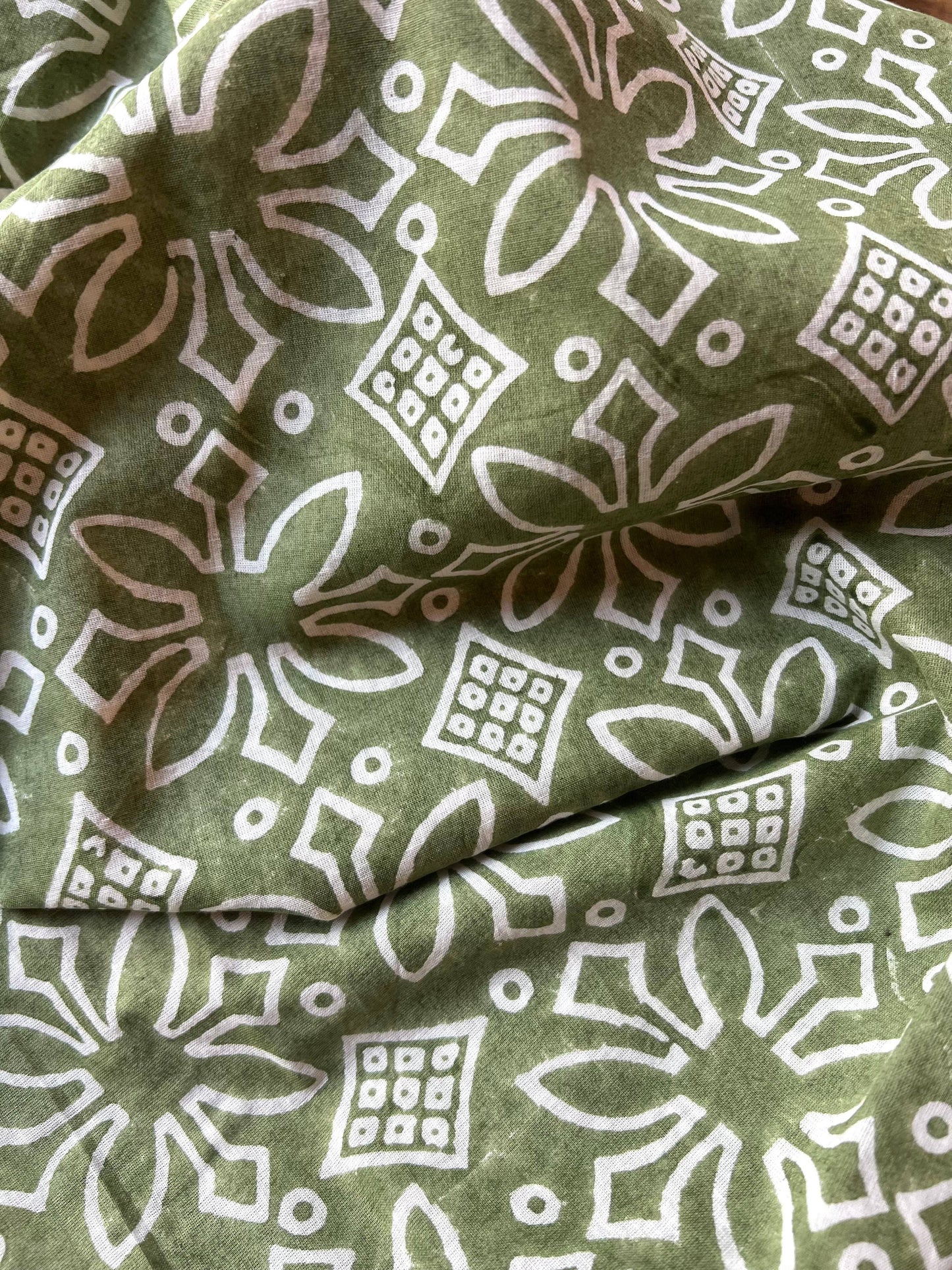 Green fabric with white geometric pattern