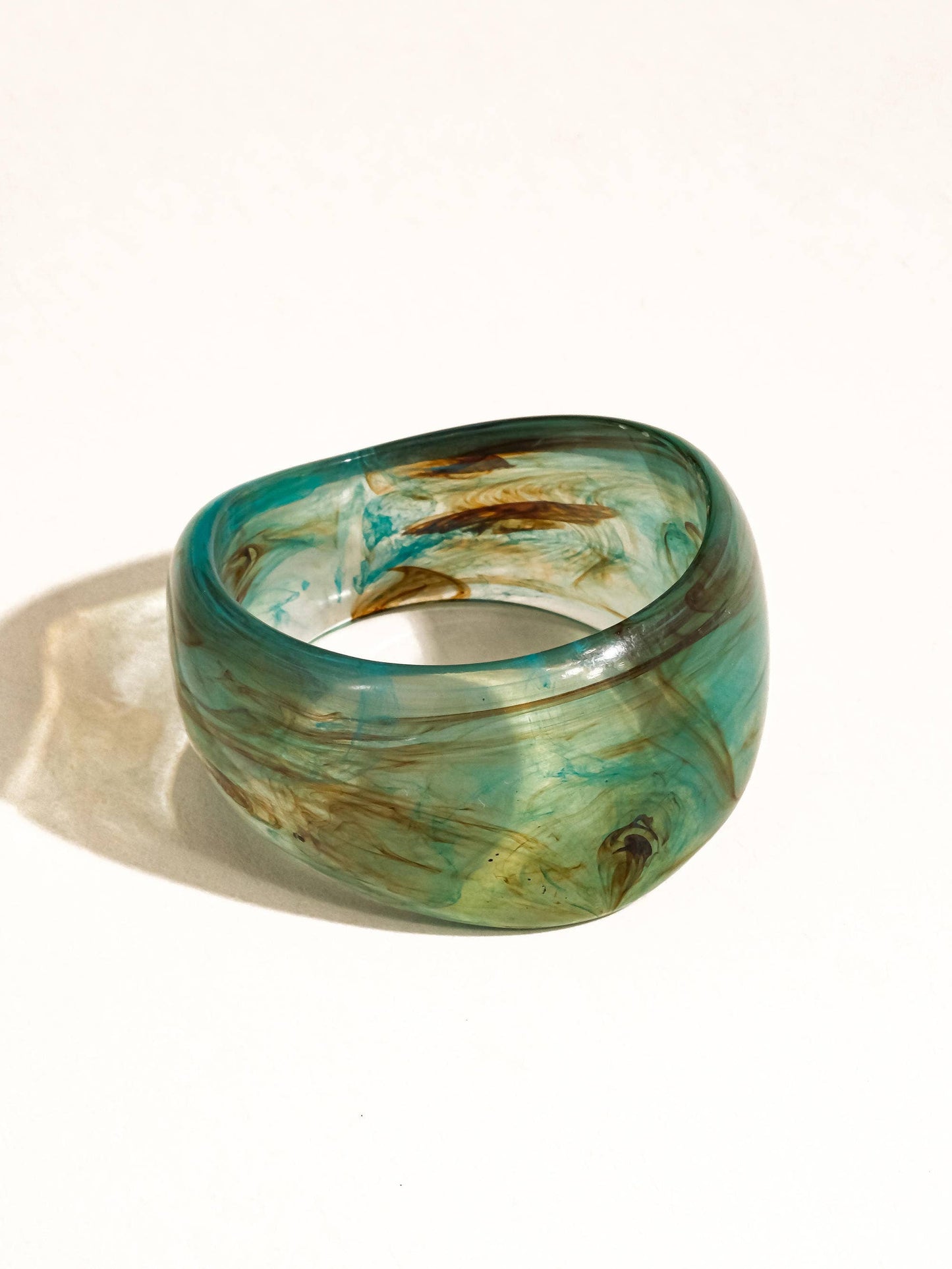 Green and brown marbled bangle on a white background