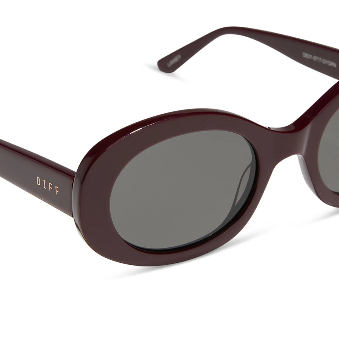 Sunglasses with dark lenses and cherry wine red frame on a white background