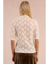 Person wearing a floral blouse with a plain background