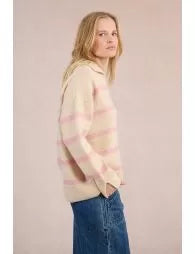 Woman wearing a striped sweater and jeans