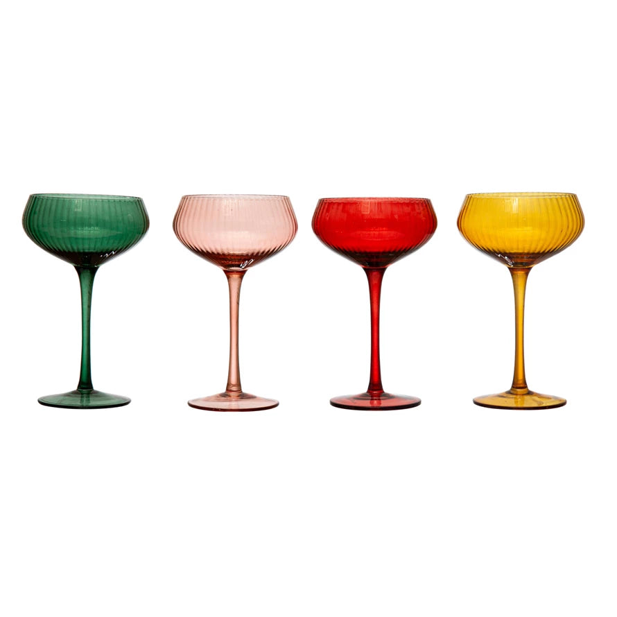 Four colorful glass goblets on a white background
