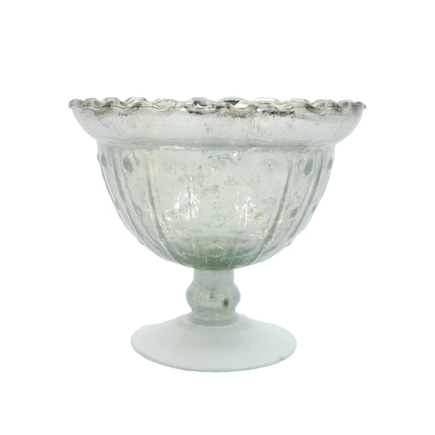 Decorative glass bowl with textured surface on a white background