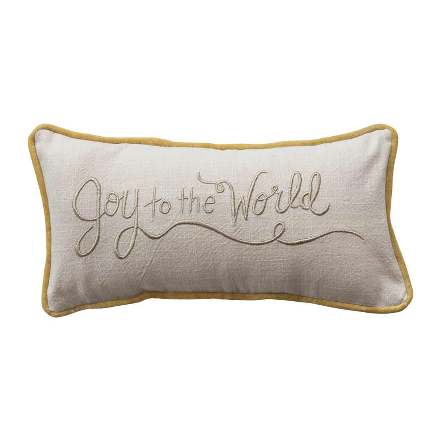 Decorative pillow with 'Joy to the World' embroidery on a white background