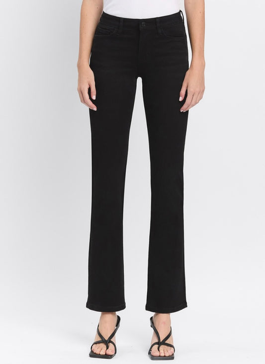 Person wearing black jeans on a white background