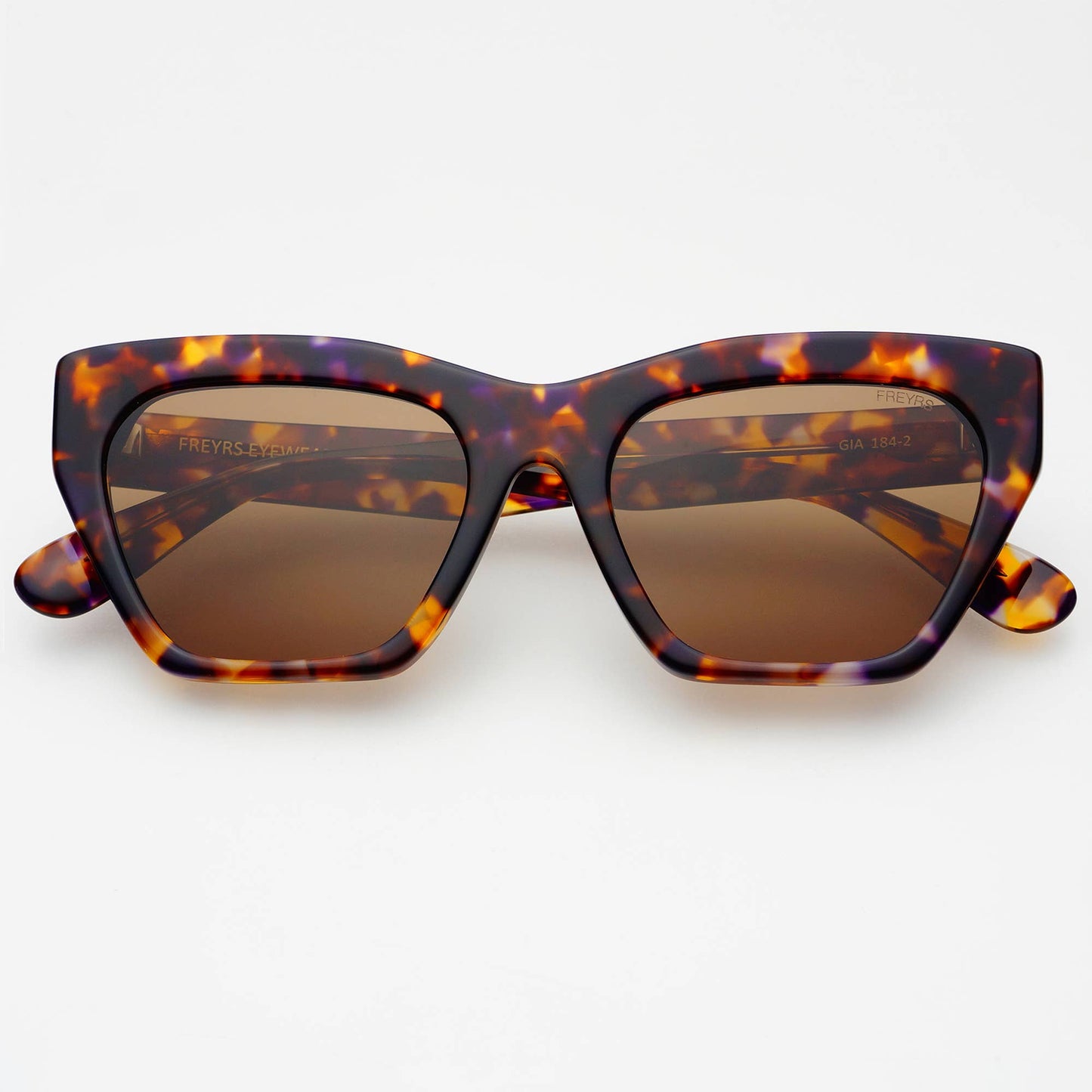 Tortoiseshell sunglasses with brown lenses on a white background