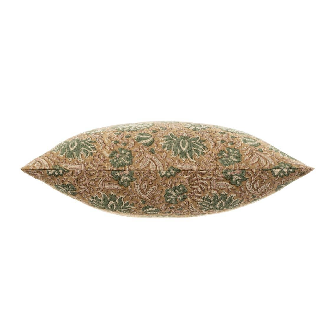 Decorative pillow with green leaf pattern on a beige background
