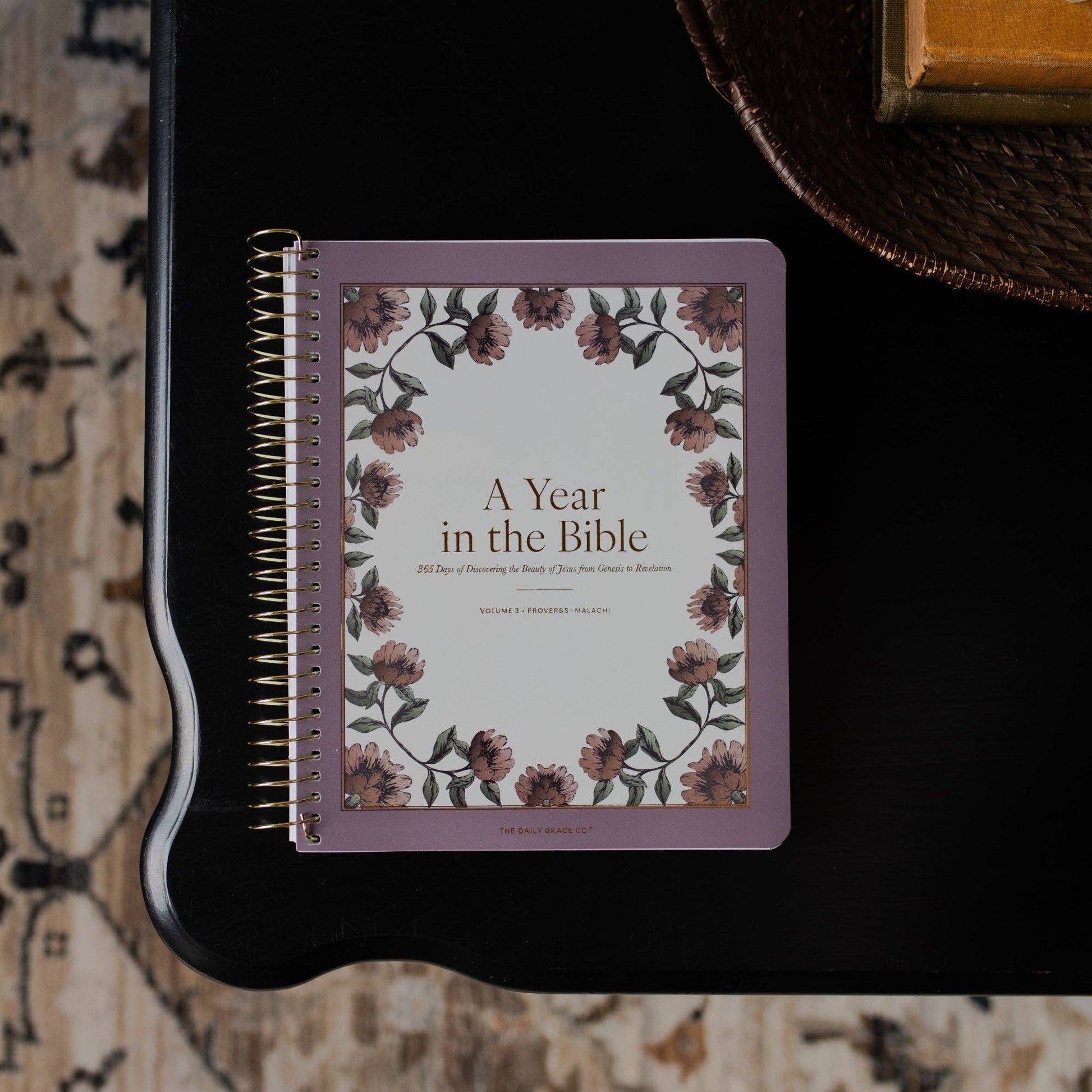 Notebook titled 'A Year in the Bible' with floral design on a textured surface