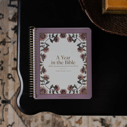 Notebook titled 'A Year in the Bible' with floral design on a textured surface