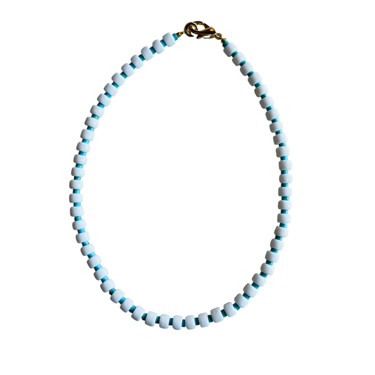 Necklace with white and blue beads on a white background