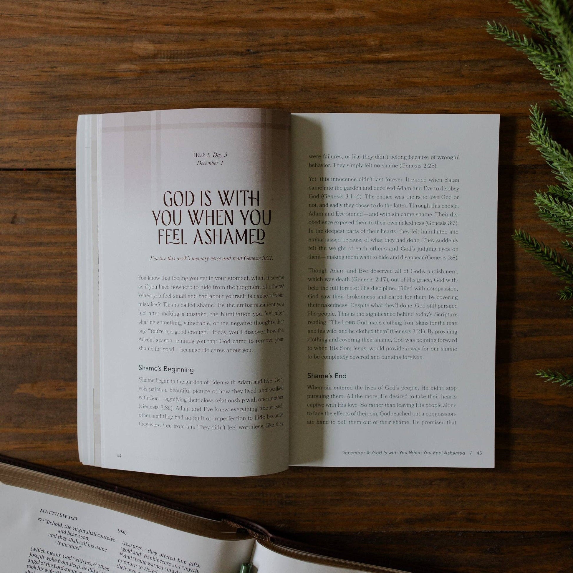 Open book on a wooden surface with a motivational quote about God being with you when you feel ashamed.