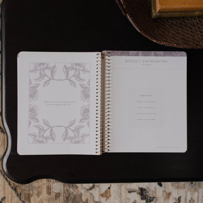 Open notebook with decorative pages on a dark surface