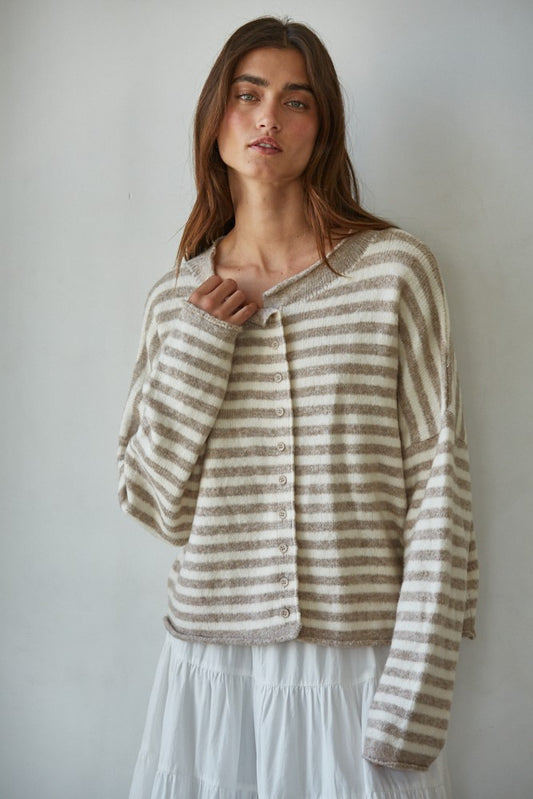 Woman wearing a striped sweater against a plain background
