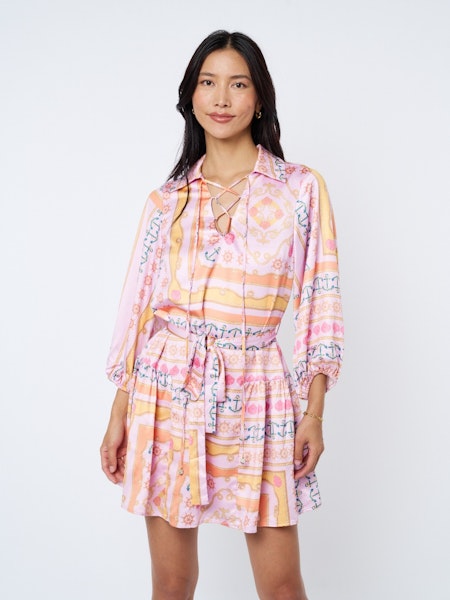 Woman wearing a colorful patterned dress on a white background