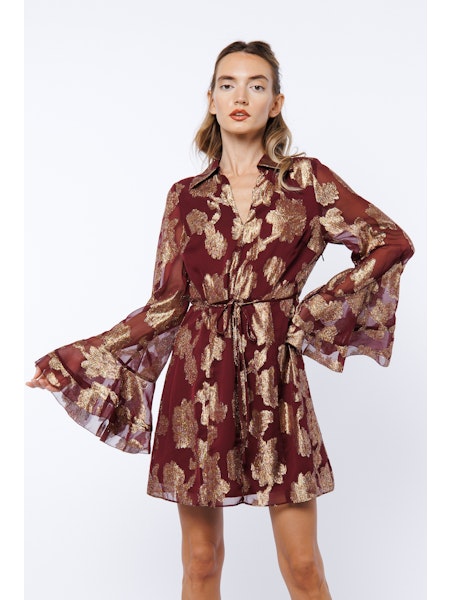 Woman wearing a floral patterned dress on a white background