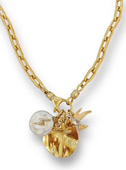 Gold necklace with various charms on a white background