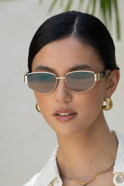 Woman wearing sunglasses with a neutral background