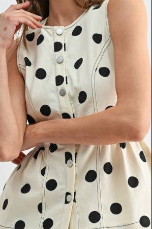Woman wearing a polka dot shirt 
on a white background