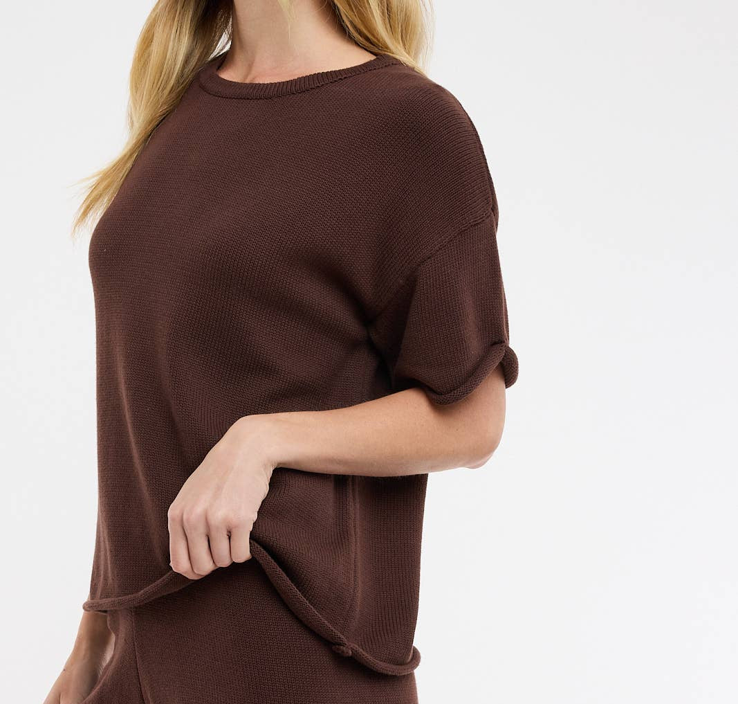 Woman wearing a brown outfit on a white background