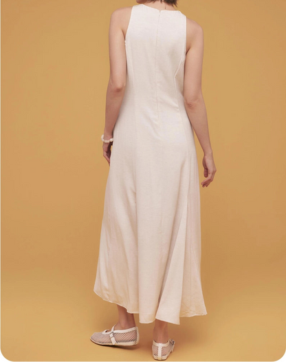 Woman wearing a white dress against a yellow background