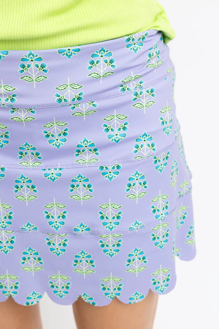 Purple floral patterned skirt with green accents on a plain background