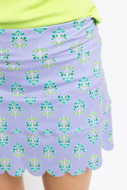 Purple floral patterned skirt with green accents on a plain background