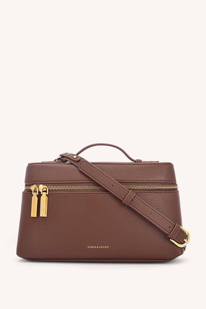 Brown handbag with gold zippers and strap on a white background