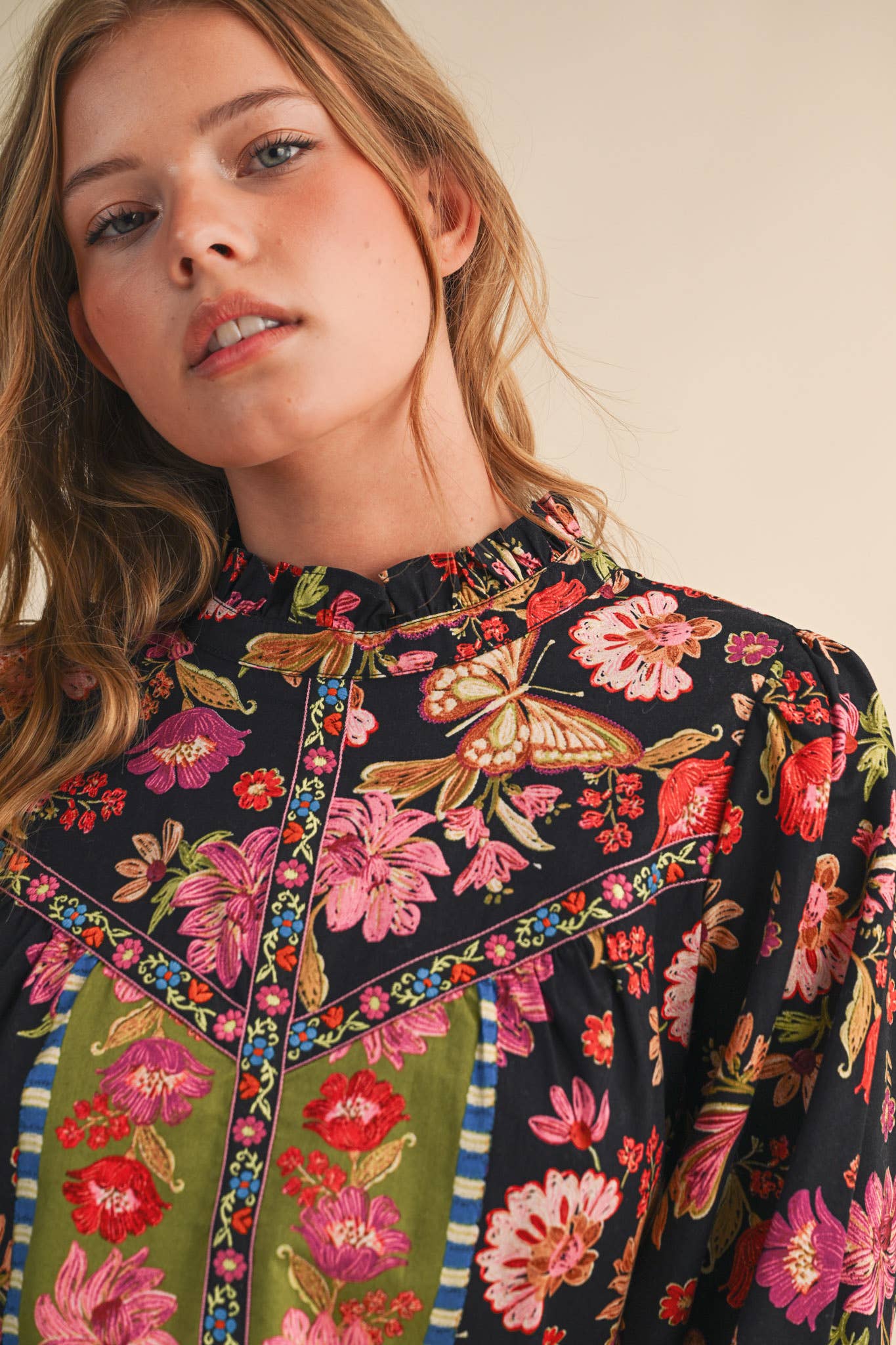 Woman wearing a floral blouse with a colorful pattern