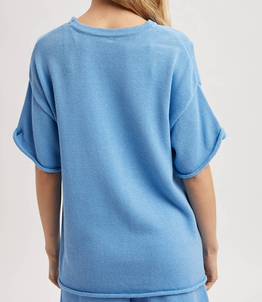 Person wearing a blue outfit with a plain background
