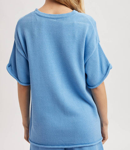 Person wearing a blue outfit with a plain background