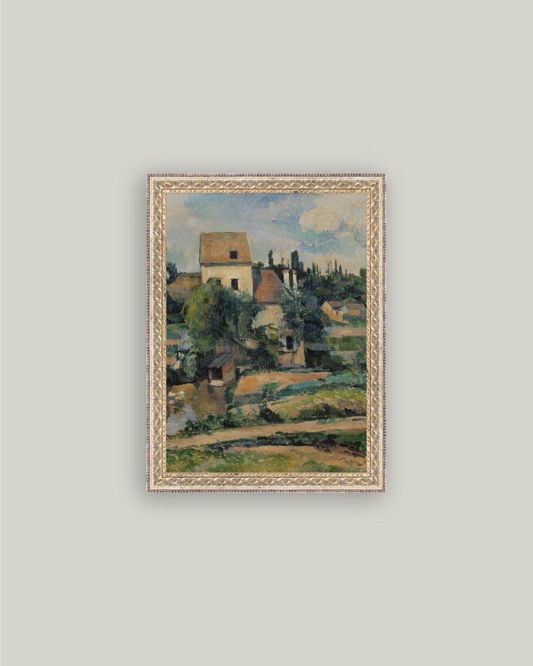 Framed painting of a landscape with houses and trees on a light gray wall.