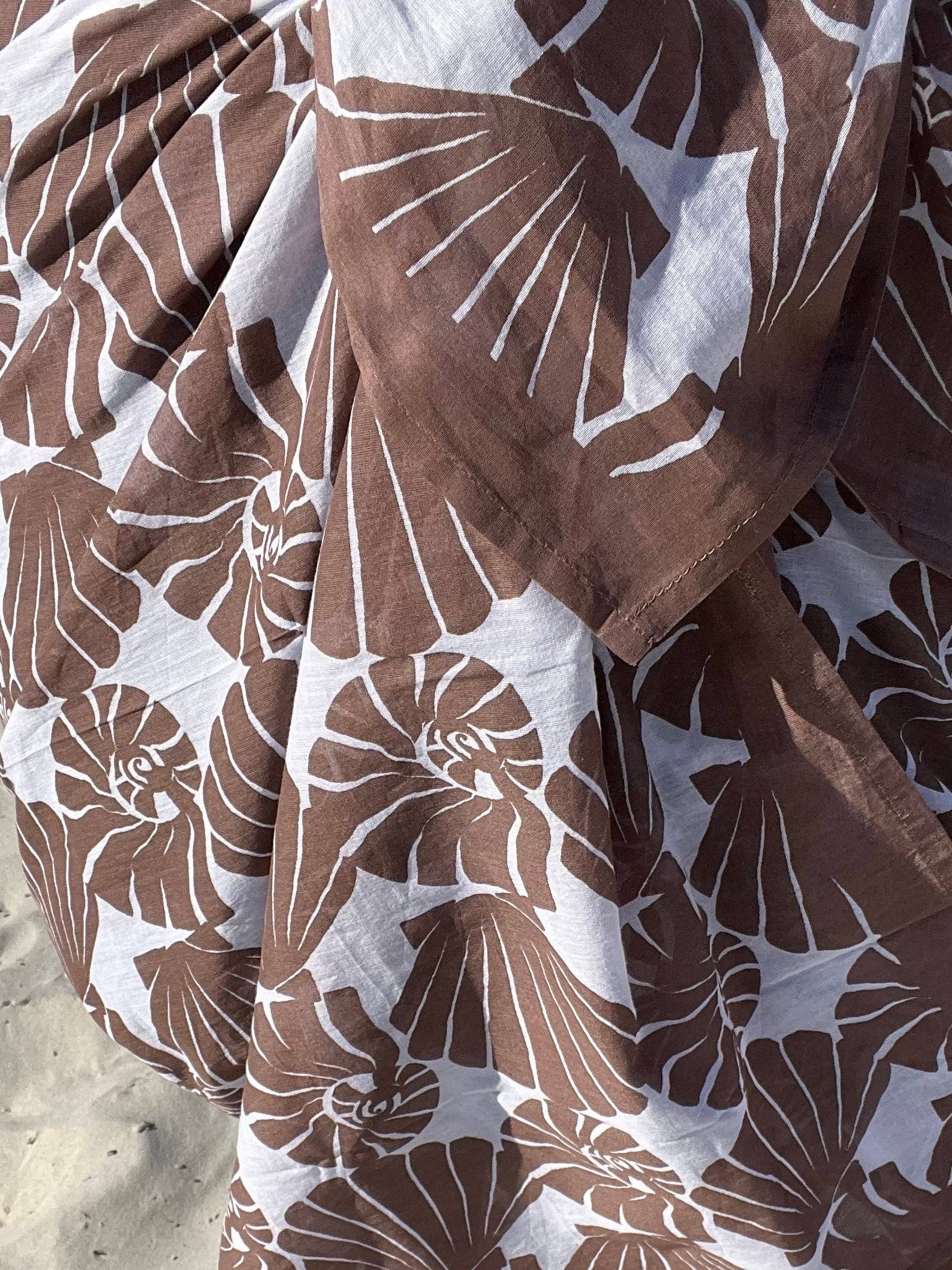 Brown and white patterned fabric on a textured surface