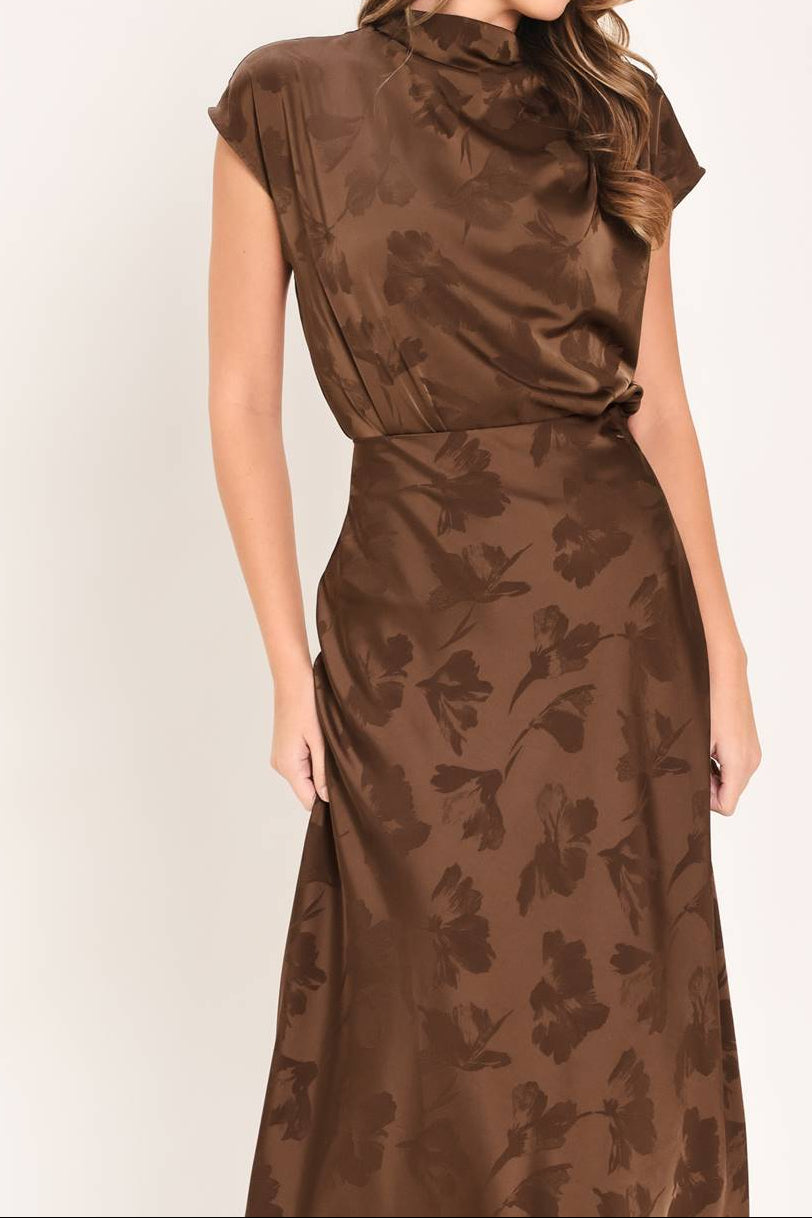 Woman wearing a brown floral set on a white background