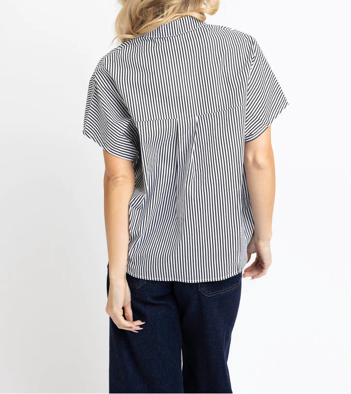 Woman wearing a black and white striped shirt on a white background