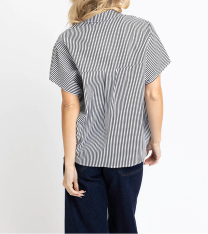 Woman wearing a black and white striped shirt on a white background