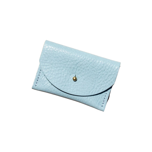 Light blue wallet with a gold button on a beige background