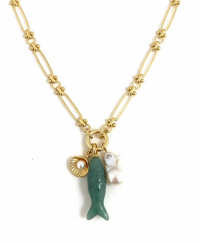 Necklace with a green fish charm and pearl on a gold chain against a white background